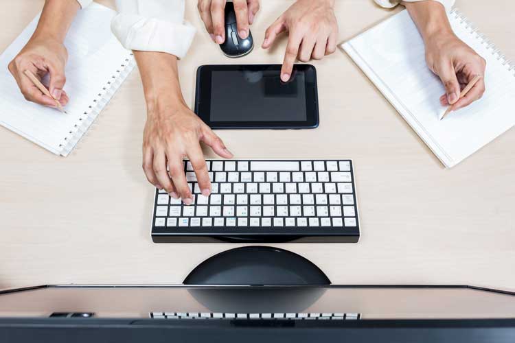 seo boston agency concept art of many hands working on computer and tablet and paper