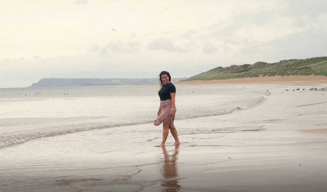 woman on east strand beach, antrim coast